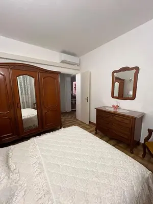 a bedroom with a bed and a dresser and a mirror at Résidence LO MONACO Haut de villa, Appartements et Studios in San-Nicolao