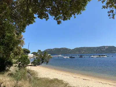a view of a beach with boats in the water at Appartement Marina di Fiori by Intendance Excellency in Porto-Vecchio