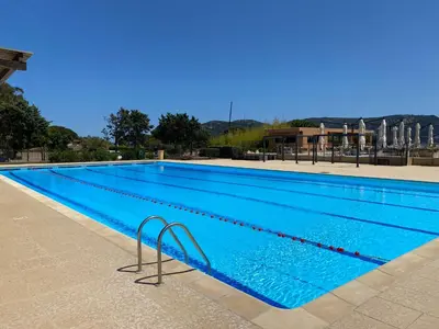 a large swimming pool with blue water at Appartement Marina di Fiori by Intendance Excellency in Porto-Vecchio