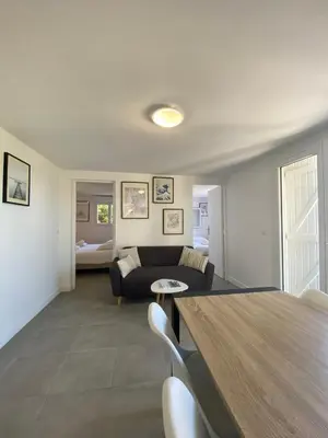 a living room with a couch and a table at Appartement Marina di Fiori by Intendance Excellency in Porto-Vecchio