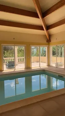 a swimming pool in a house with windows at CASA DI CAJUCAN in Poggio-dʼOletta