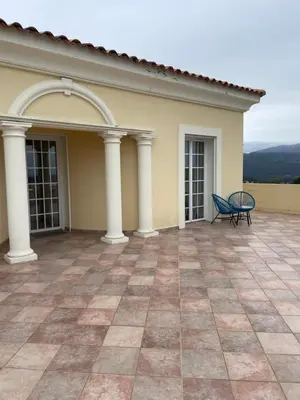 a patio with a blue chair on top of a house at CASA DI CAJUCAN in Poggio-dʼOletta