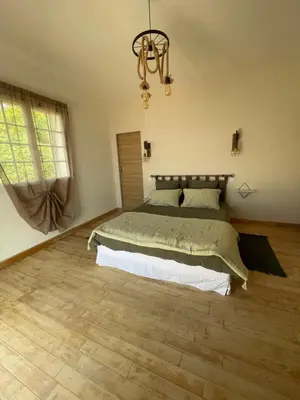 a bedroom with a bed and a chandelier at CASA DI CAJUCAN in Poggio-dʼOletta