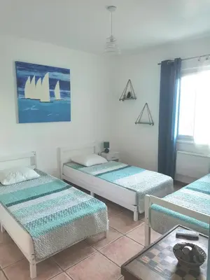 a room with three beds and a window at Rez Haut de villa à Calenzana in Calenzana