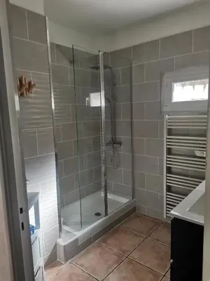 a shower with a glass door in a bathroom at Rez Haut de villa à Calenzana in Calenzana
