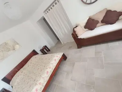 a living room with a bed and a couch at Maison de charme proche Bastia in Prunelli-di-Casacconi