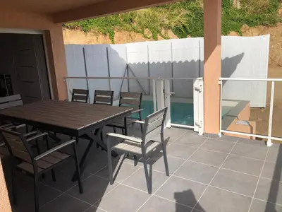 a wooden table and chairs on a patio at Casa campa lumba in Propriano