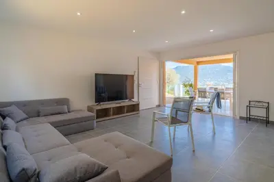 a living room with a couch and a television at Casa campa lumba in Propriano