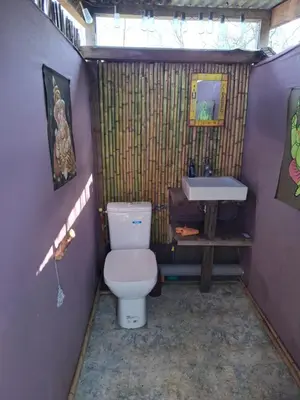 a small bathroom with a toilet and a sink at Caravane amy on the beach in Lucciana