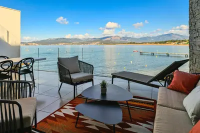 a living room with a view of the water at T2 LUXE Pieds dans l'eau Porticcio in Grosseto-Prugna