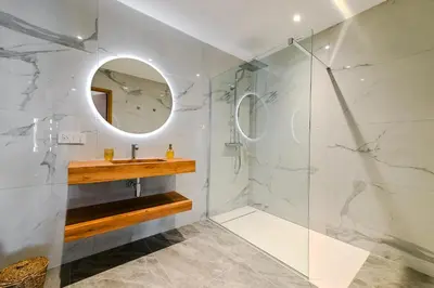 a bathroom with a sink and a mirror at T2 LUXE Pieds dans l'eau Porticcio in Grosseto-Prugna