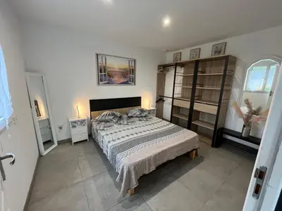 a bedroom with a large bed in a room at La Détente in Bonifacio