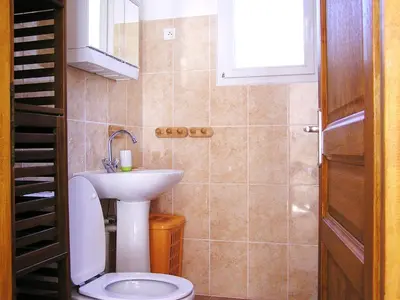 a bathroom with a toilet and a sink at Residence Cucunacciu in Cargèse