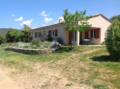a small house with a tree in front of it at Residence Cucunacciu in Cargèse