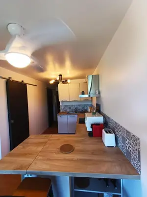 a kitchen with a large wooden counter top in a room at Porticcio avec Piscine proche plage in Porticcio