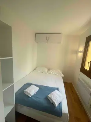 a bedroom with a bed with two towels on it at Porticcio avec Piscine proche plage in Porticcio