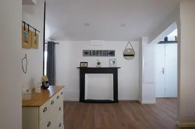 a living room with a fireplace and a table at F2 Type LOFT à Ajaccio in Ajaccio