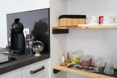 a kitchen with a coffee maker on a counter at F2 Type LOFT à Ajaccio in Ajaccio