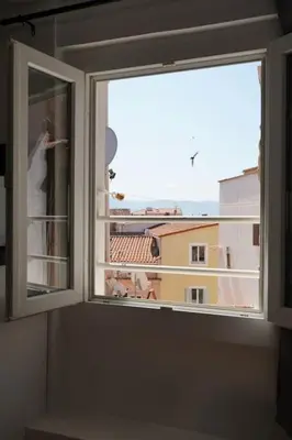 a window with a view of a city at F2 Type LOFT à Ajaccio in Ajaccio