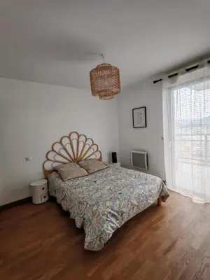 a bedroom with a bed and a large window at Appartement terrasse spacieuse, vue mer & clim in Ajaccio