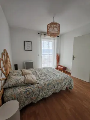 a bedroom with a large bed in a room at Appartement terrasse spacieuse, vue mer & clim in Ajaccio