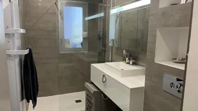 a bathroom with a sink and a mirror at Le Rocher Des Sanguinaires in Ajaccio