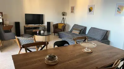 a living room with a table and a couch at Le Rocher Des Sanguinaires in Ajaccio