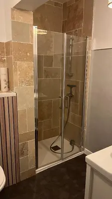 a shower with a glass door in a bathroom at Le Rocher Des Sanguinaires in Ajaccio