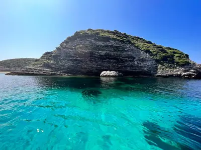 an island in the middle of the water at La poudrière in Figari