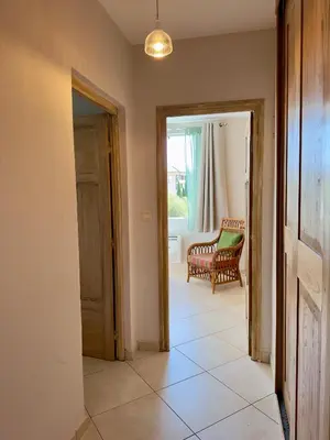 a hallway with a door and a chair in a room at *.* Haut de villa U Nespulu di Anghjulina *.* in Borgo