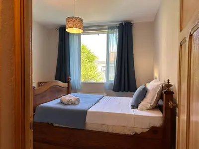 a bedroom with a bed with a window at *.* Haut de villa U Nespulu di Anghjulina *.* in Borgo
