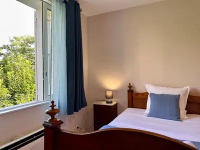 a bedroom with a bed and a window at *.* Haut de villa U Nespulu di Anghjulina *.* in Borgo