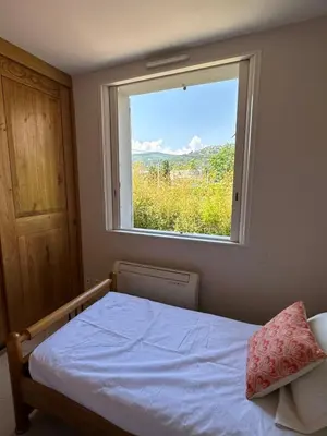 a bedroom with a bed and a window at *.* Haut de villa U Nespulu di Anghjulina *.* in Borgo