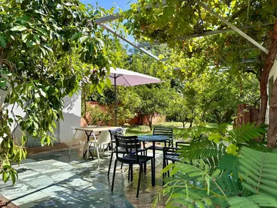 a patio with a table and chairs and an umbrella at *.* Haut de villa U Nespulu di Anghjulina *.* in Borgo