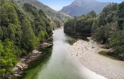 a river in the middle of a valley with trees at 1 Bedroom Lovely Apartment In Ghisoni in Ghisoni