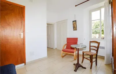 a room with a table and chairs and a window at 1 Bedroom Lovely Apartment In Ghisoni in Ghisoni
