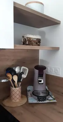 a kitchen counter with a coffee maker and utensils at Casa corsica in Pianottoli-Caldarello