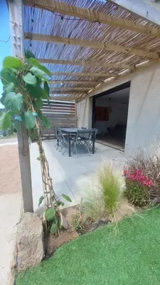 a patio with a table and a picnic table at Casa corsica in Pianottoli-Caldarello