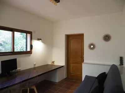 a living room with a couch and a table and a door at MAMMONA in Bonifacio