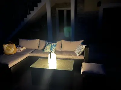 a living room with a couch with a candle on a table at Villa Héliopolis in Ventiseri