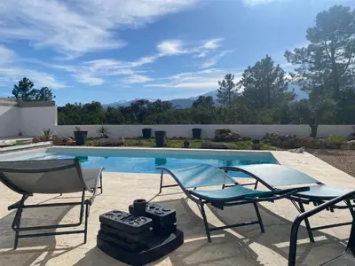 two chairs sitting next to a swimming pool at Villa Vittoria in Ghisonaccia