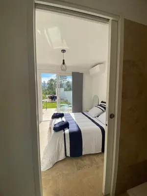 a bedroom with two beds and a large window at Villa Vittoria in Ghisonaccia