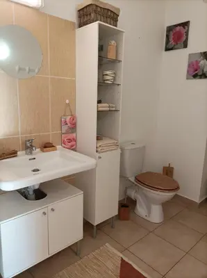 a sliding glass door leading to a patio with a table at Appartement T2 bord de mer/piscines in Moriani Plage