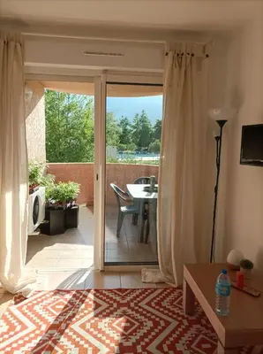 a balcony with a view of a mountain at Appartement T2 bord de mer/piscines in Moriani Plage