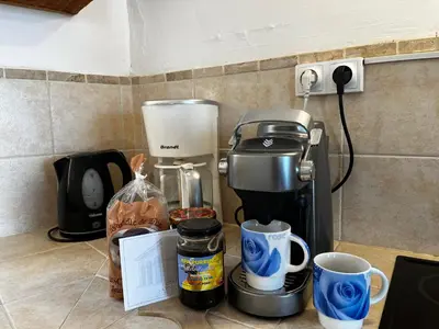 a coffee maker and coffee cups on a counter at Gîtes la fontaine corse vue panoramique in Loreto-di-Casinca