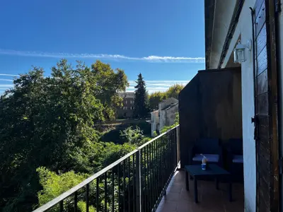 a balcony with a view of the water at Gîtes la fontaine corse vue panoramique in Loreto-di-Casinca