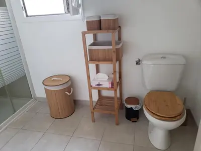 a bathroom with a toilet and a wooden shelf at VILLA MARYSABEL , maison T4 duplex, résidence villa de melody avec 2 piscines, mer à 500 m in Santa-Maria-Poggio