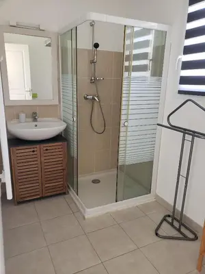 a bathroom with a glass shower and a sink at VILLA MARYSABEL , maison T4 duplex, résidence villa de melody avec 2 piscines, mer à 500 m in Santa-Maria-Poggio