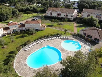 an aerial view of two large pools in a yard at VILLA MARYSABEL , maison T4 duplex, résidence villa de melody avec 2 piscines, mer à 500 m in Santa-Maria-Poggio