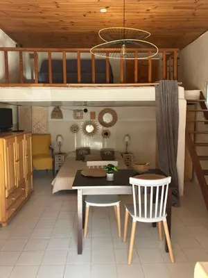 a bedroom with a bed and a table and chairs at Studio Olmeto in Olmeto